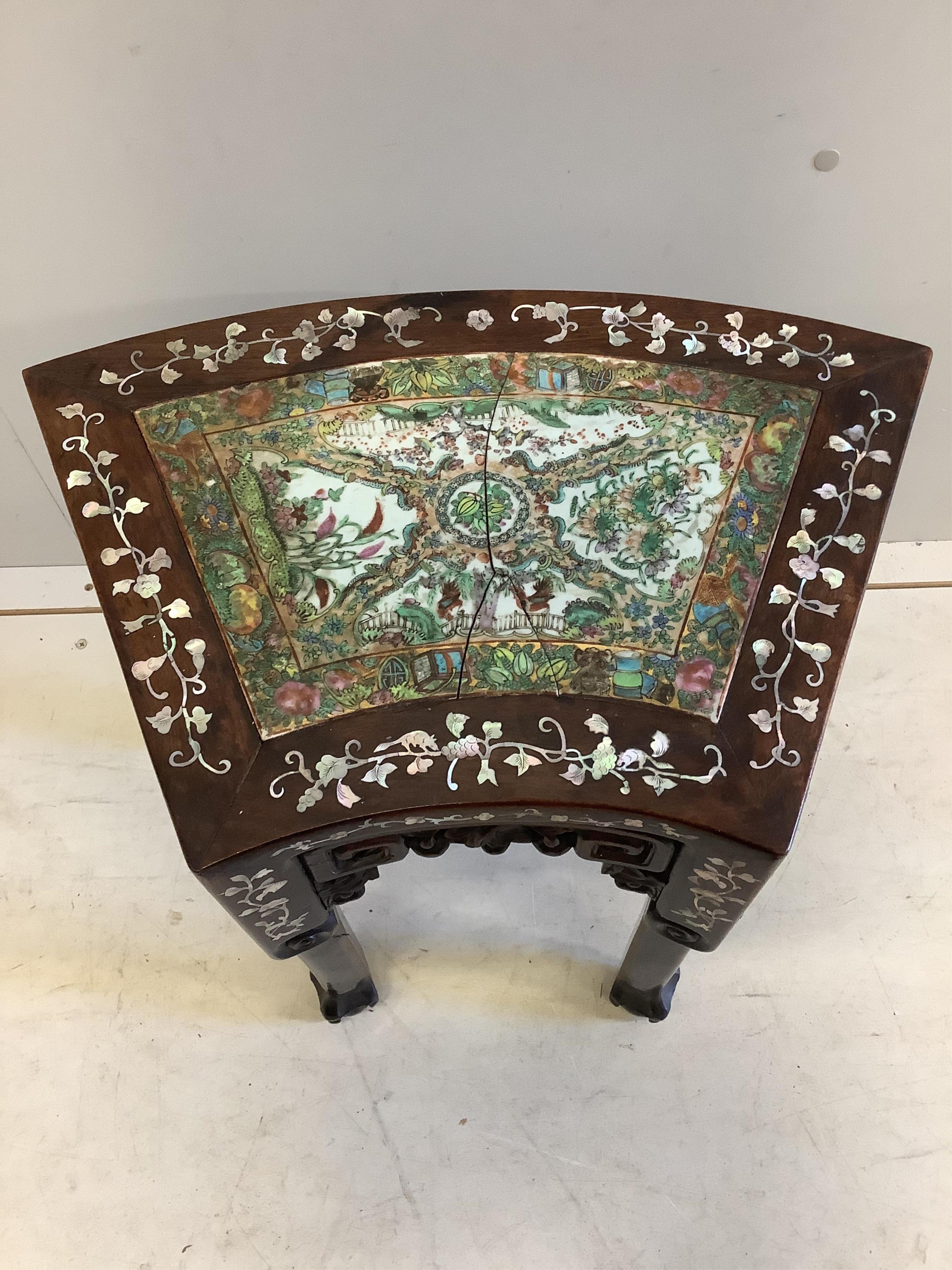 A Chinese mother of pearl inlaid hongmu vase stand, with famille rose porcelain inset top, (cracked), width 49cm, depth 31cm, height 47cm